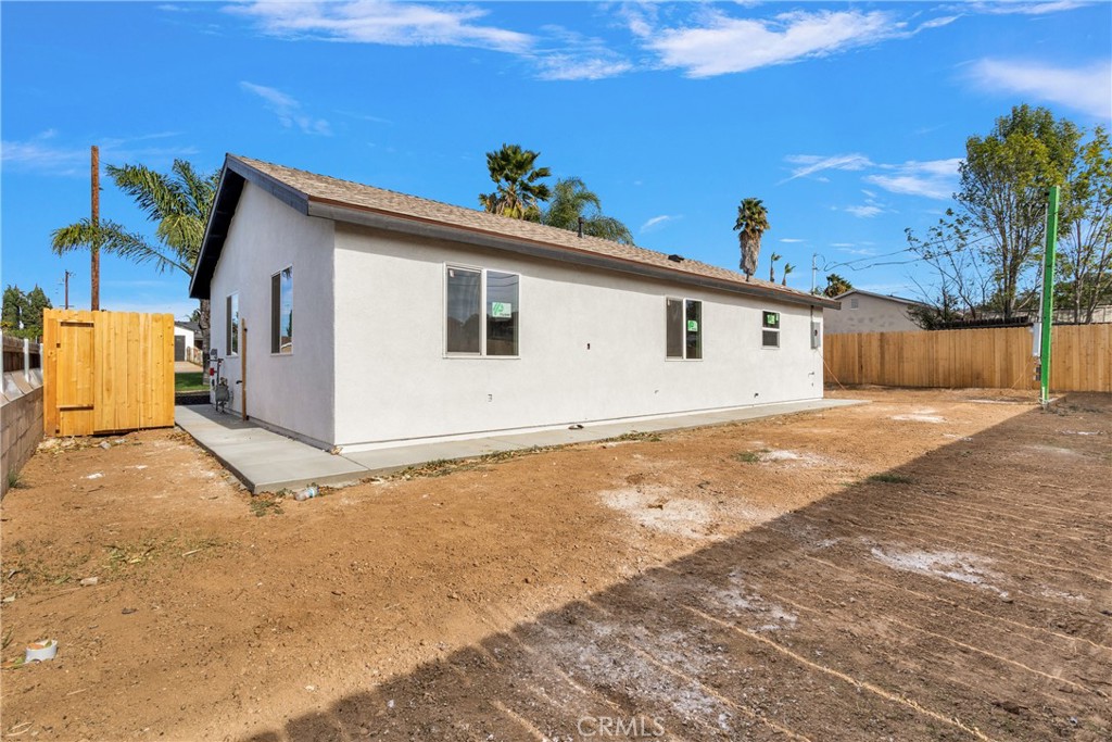 3308 Cannes Avenue Riverside, CA 92501 - Photo 29 of 38 a view of a house with a wooden fence