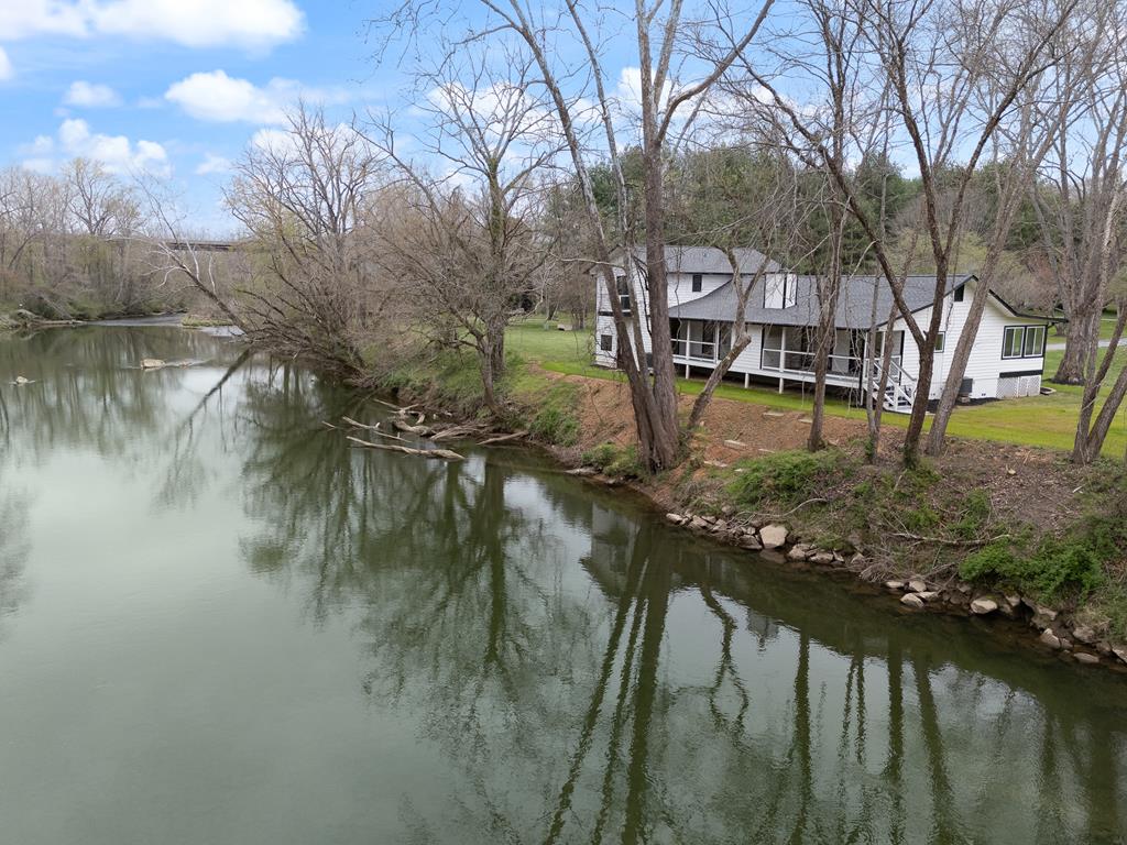 a view of a lake with a house in the background