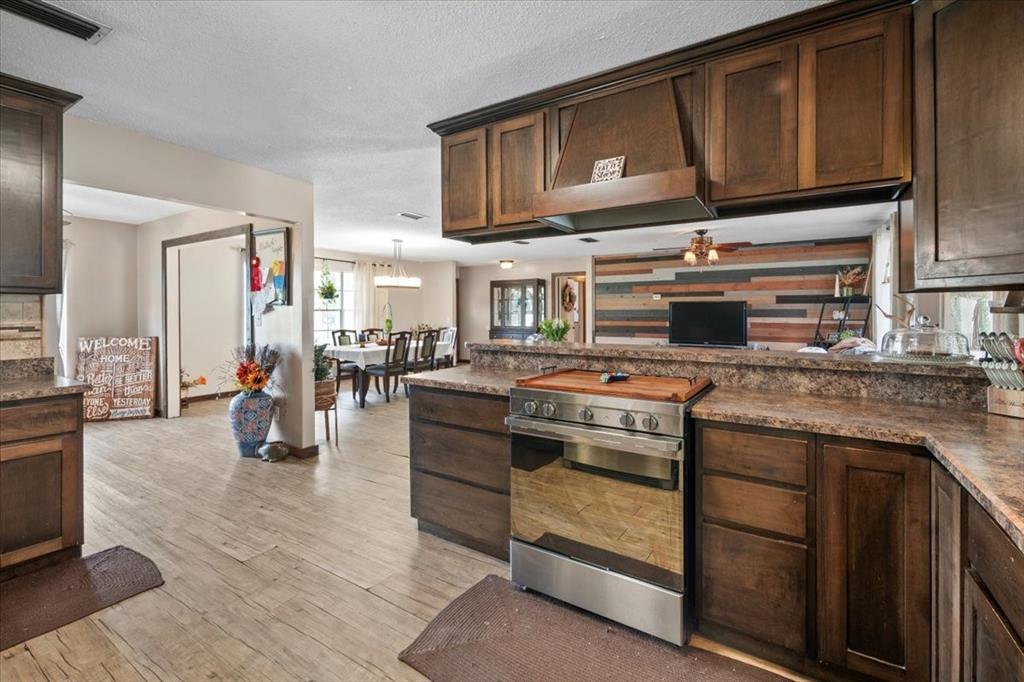 7422 County Road 231 Lake Butler, FL 32054 - Photo 16 of 57 a kitchen with stainless steel appliances granite countertop a stove and a sink