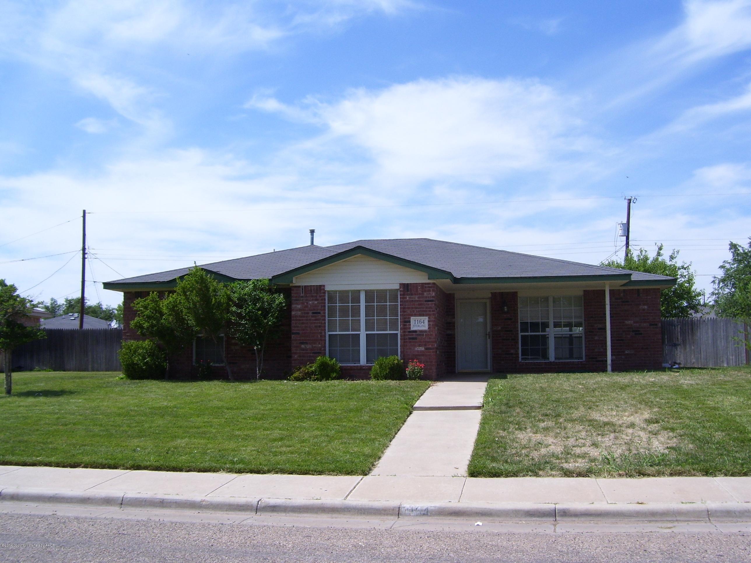 1164 Sterling Drive Amarillo, TX 79110 - Photo 1 of 24 a view of a brick house next to a yard with large trees