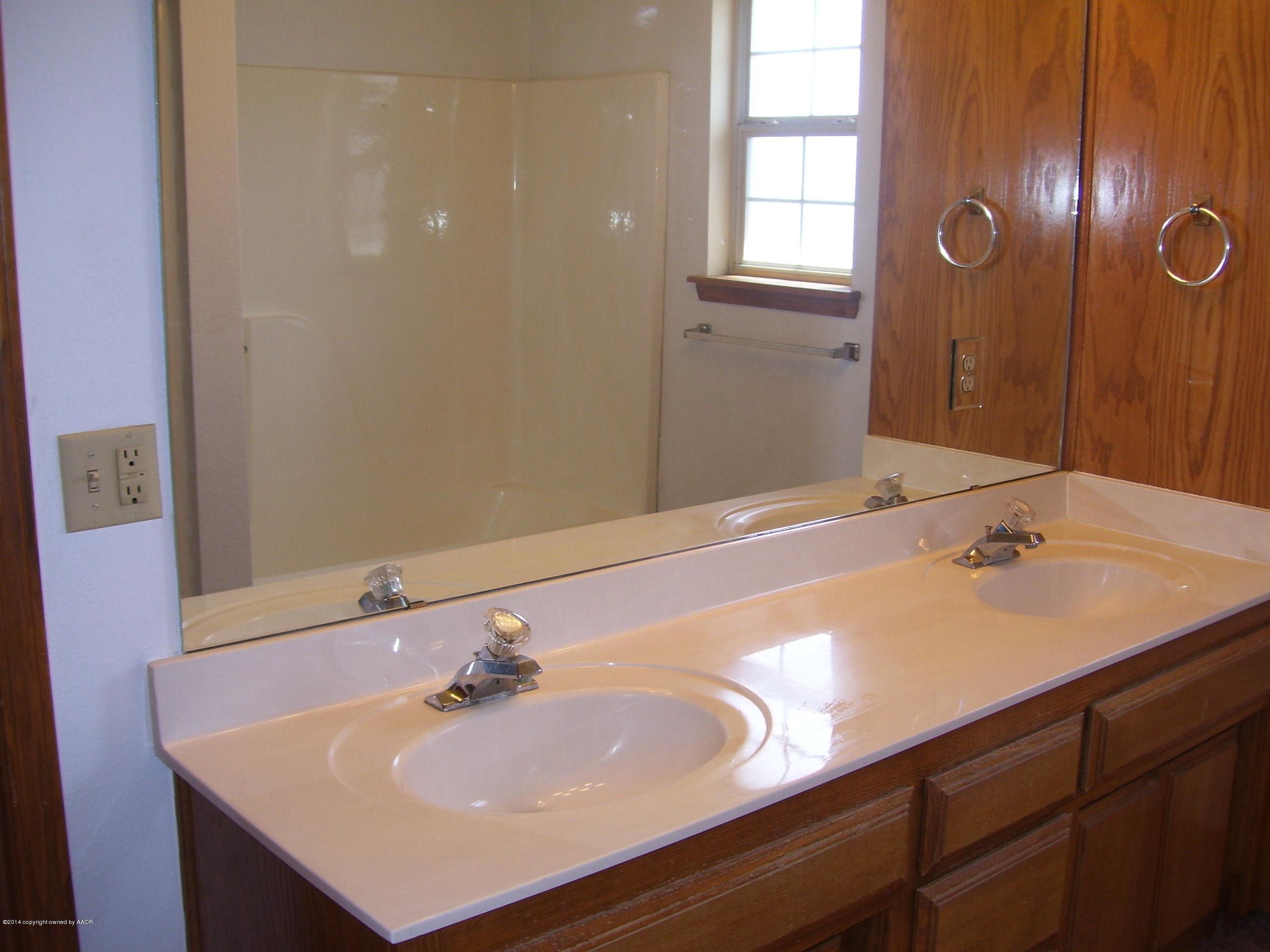 1164 Sterling Drive Amarillo, TX 79110 - Photo 13 of 24 a bathroom with a sink and a mirror