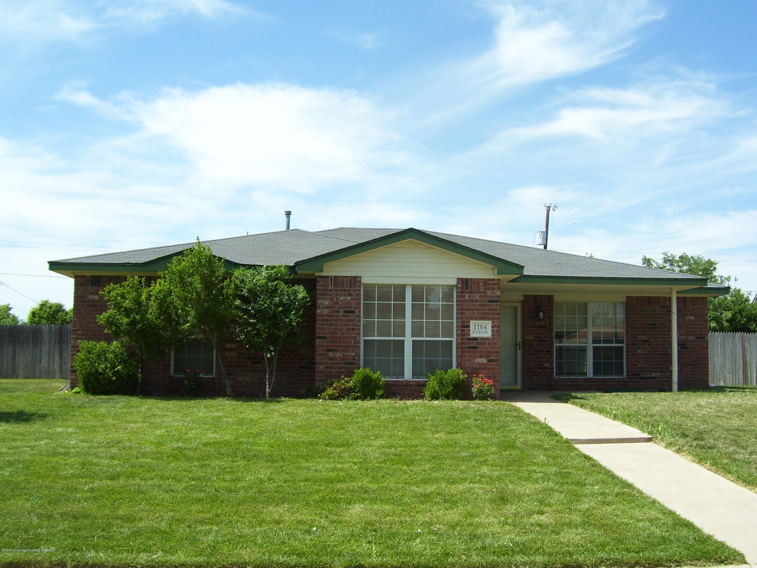1164 Sterling Drive Amarillo, TX 79110 - Photo 3 of 24 a view of a brick house with a yard