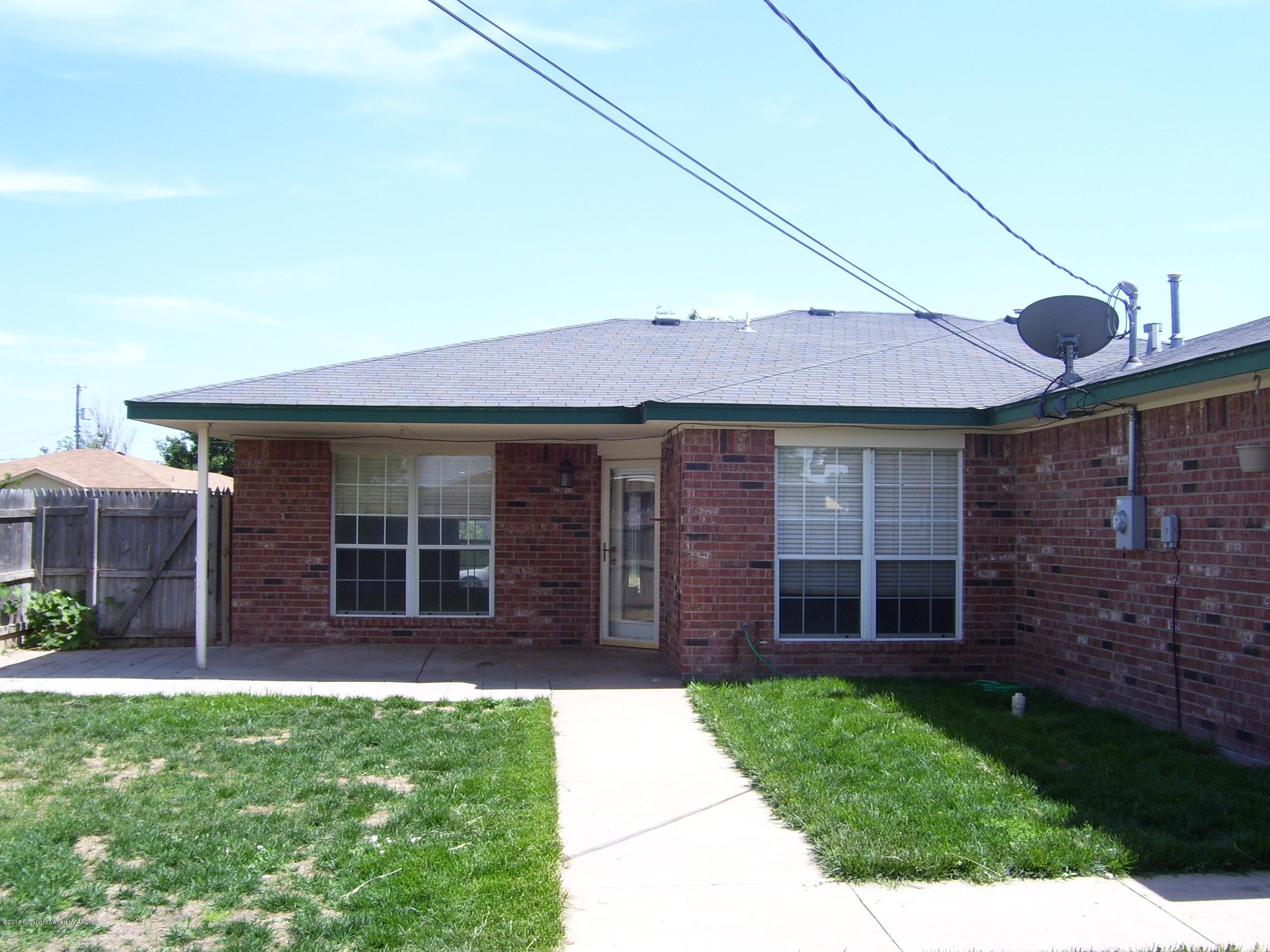 1164 Sterling Drive Amarillo, TX 79110 - Photo 21 of 24 a view of a brick house with a large window and a yard