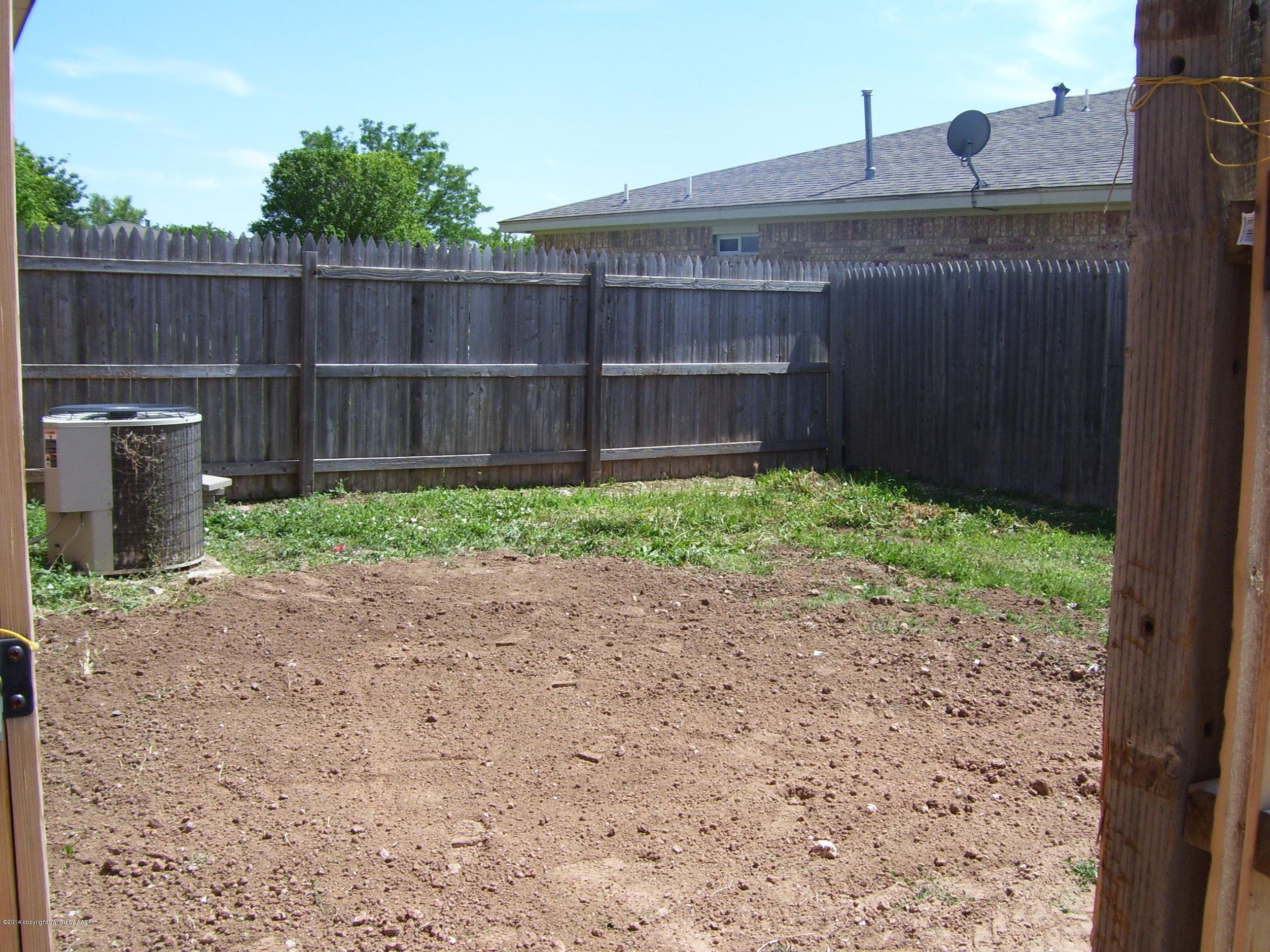 1164 Sterling Drive Amarillo, TX 79110 - Photo 22 of 24 a view of a backyard with wooden fence