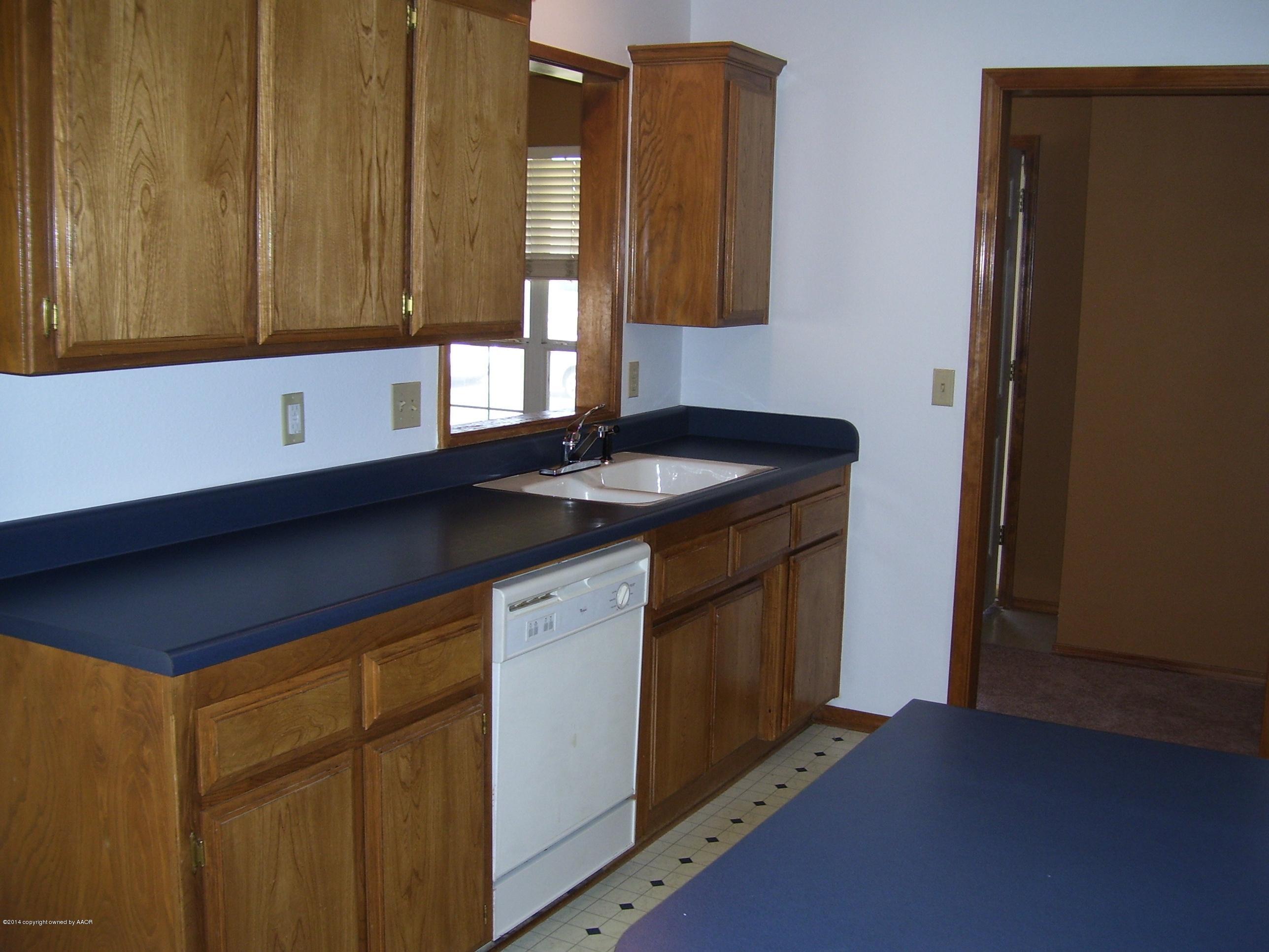 1164 Sterling Drive Amarillo, TX 79110 - Photo 9 of 24 a kitchen with a sink and a window