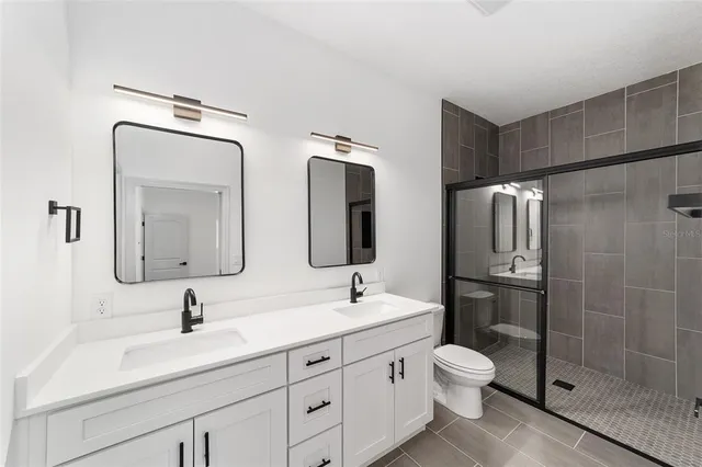 a bathroom with double sink and a mirror
