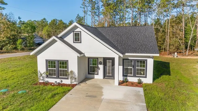 a view of house with backyard