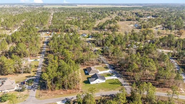 a view of residential houses with yard and mountain view