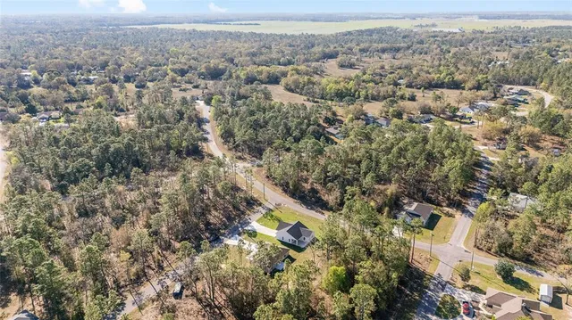 an aerial view of house with yard and mountain view in back