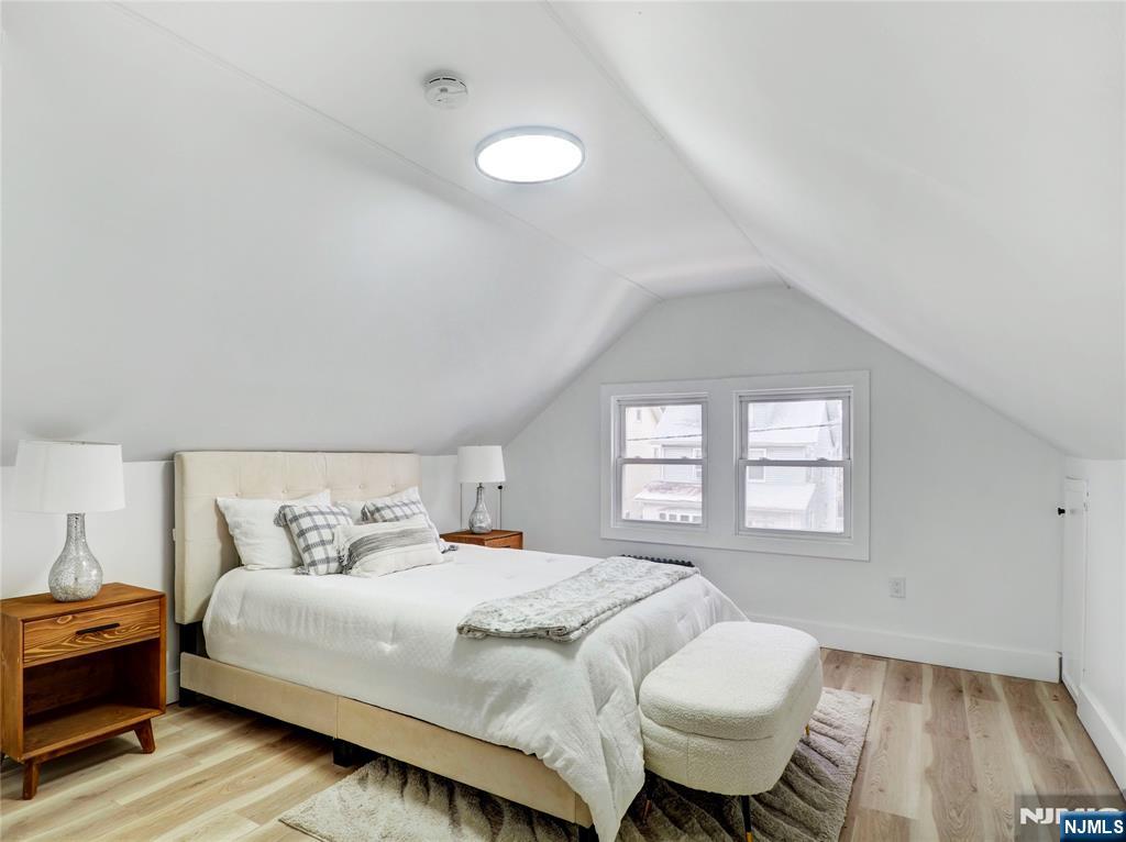 44 Laventhal Avenue Irvington, NJ 07111 - Photo 14 of 26 a bedroom with a bed and wooden floor