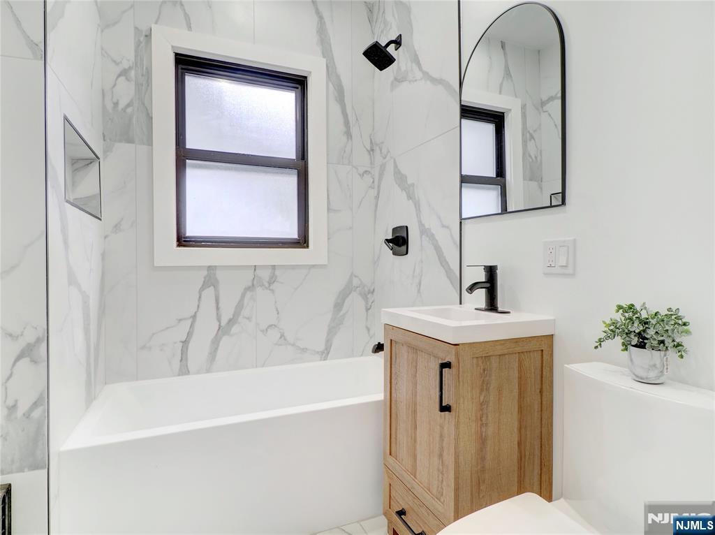 44 Laventhal Avenue Irvington, NJ 07111 - Photo 19 of 26 a bathroom with a sink a toilet and shower