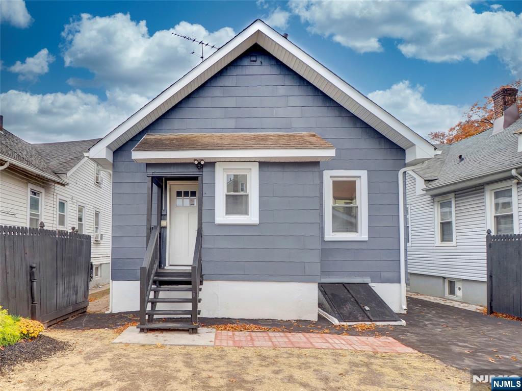 44 Laventhal Avenue Irvington, NJ 07111 - Photo 24 of 26 a front view of a house with a yard