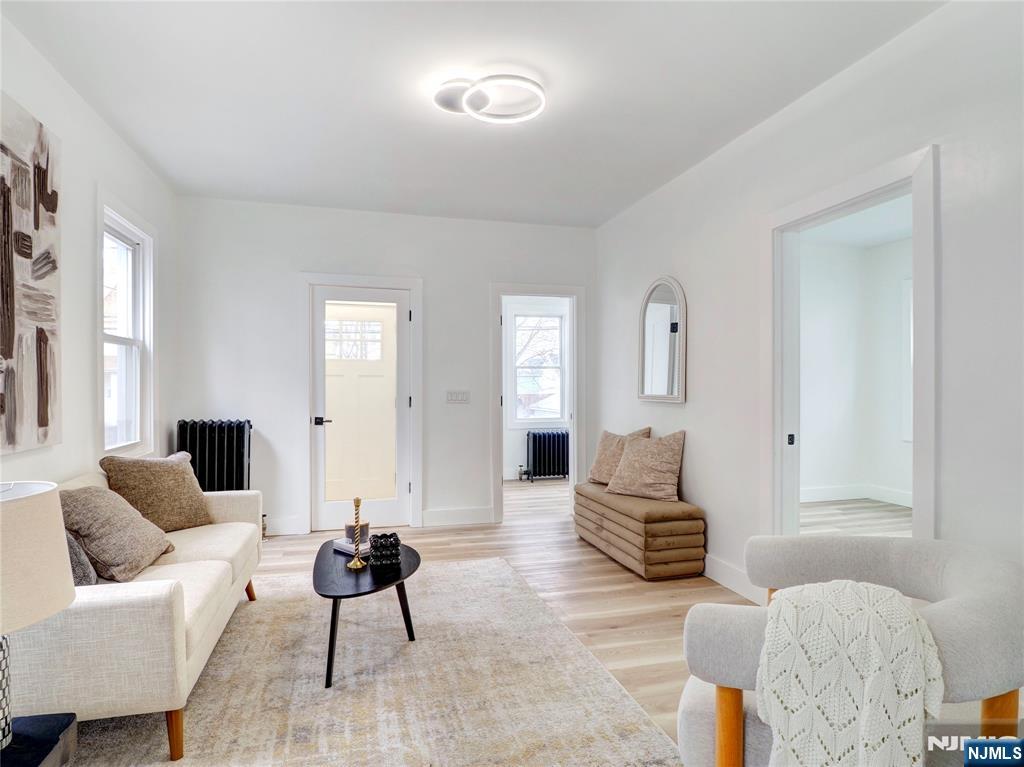 44 Laventhal Avenue Irvington, NJ 07111 - Photo 5 of 26 a living room with furniture and wooden floor