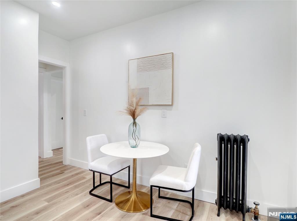 44 Laventhal Avenue Irvington, NJ 07111 - Photo 10 of 26 a lamp that is sitting on a table and chair in a room