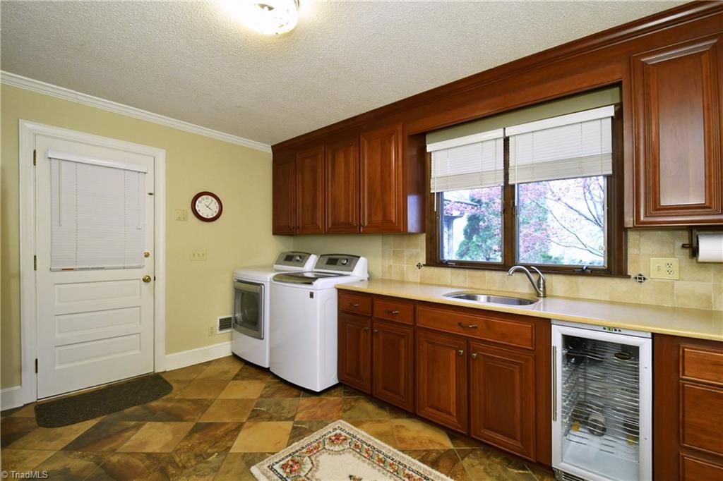 225 Cook Street Rural Hall, NC 27045 - Photo 11 of 30 Renovated oversized laundry/mudroom with abundant storage, large walk-in pantry, and a wine cooler.