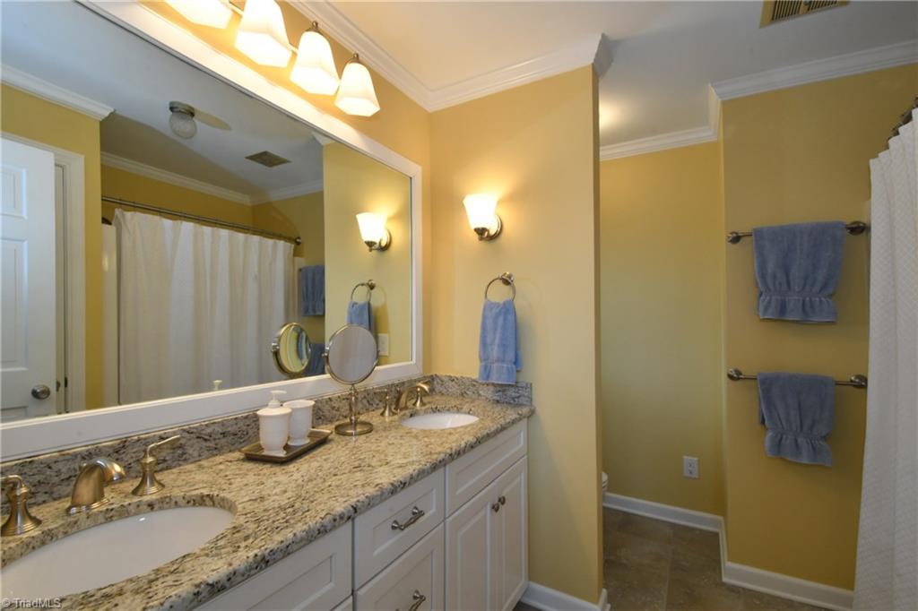 225 Cook Street Rural Hall, NC 27045 - Photo 17 of 30 Updated master bath has granite counters and double bowl vanities.