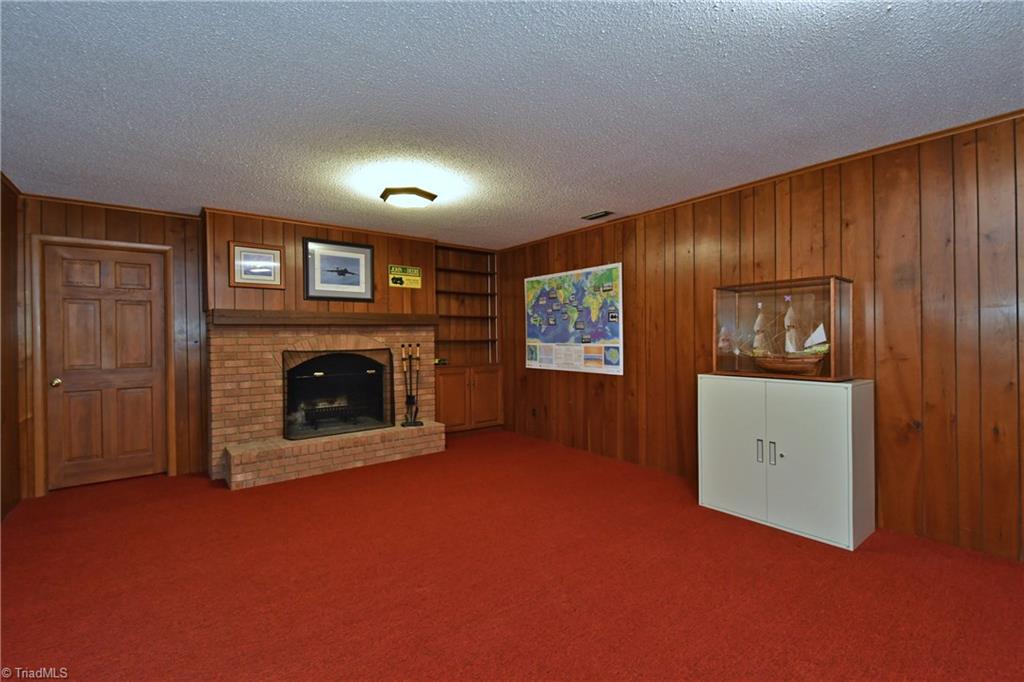 225 Cook Street Rural Hall, NC 27045 - Photo 21 of 30 Walk-out daylight flexible room in the lower level is open to the rear yard. There is also an office with closets, windows, and a full bath on this level, as well as a huge workshop that is unbelievable!!