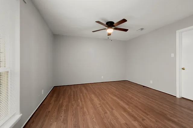 a view of an empty room and wooden floor