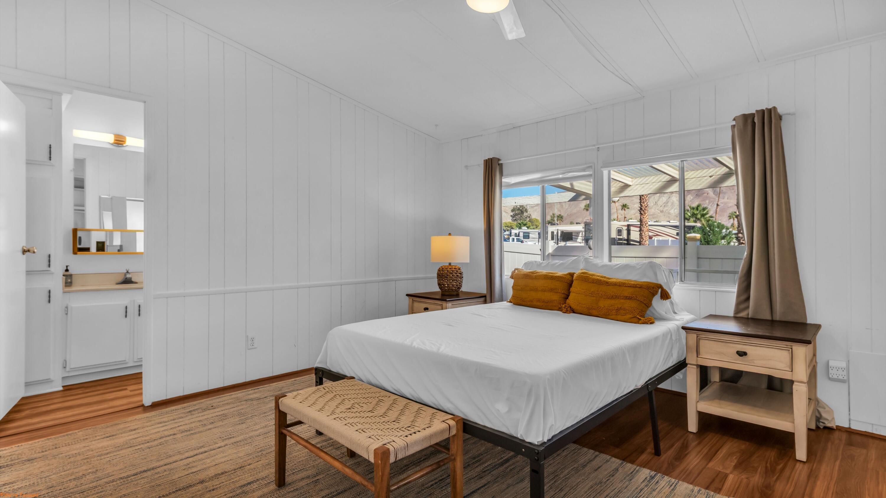 74711 Dillon Road, Unit 392 Desert Hot Springs, CA 92241 - Photo 13 of 46 a bedroom with a bed and wooden floor
