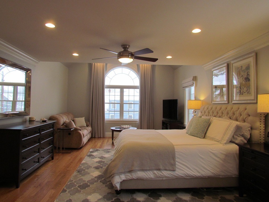 51 Ware Road Needham, MA 02492 - Photo 7 of 14 a bedroom with a bed and a chandelier