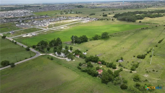 a view of a field with an ocean