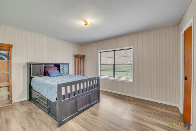 a bedroom with a bed and window