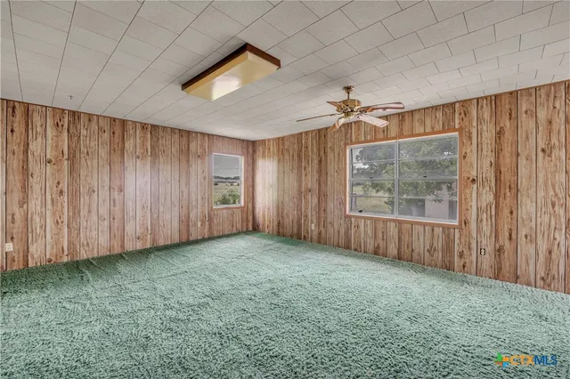 a view of a livingroom with a dishwasher cabinets and a window
