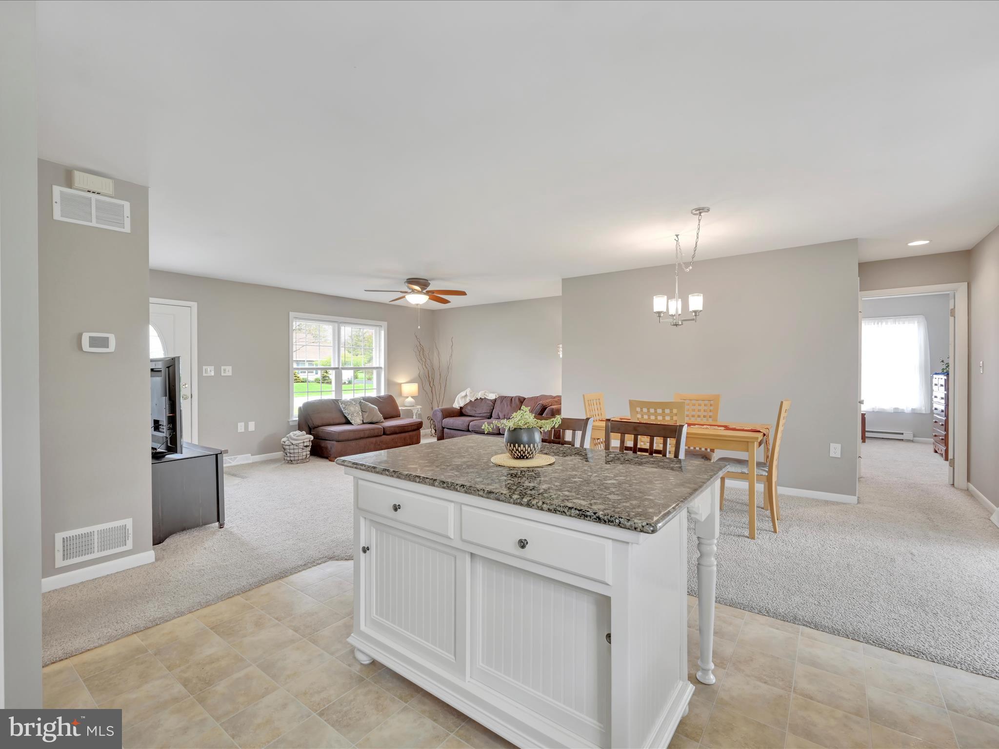 28 Buttonwood Drive Lititz, PA 17543 - Photo 11 of 32 a dining hall with stainless steel appliances granite countertop a sink a dining table and chairs with wooden floor