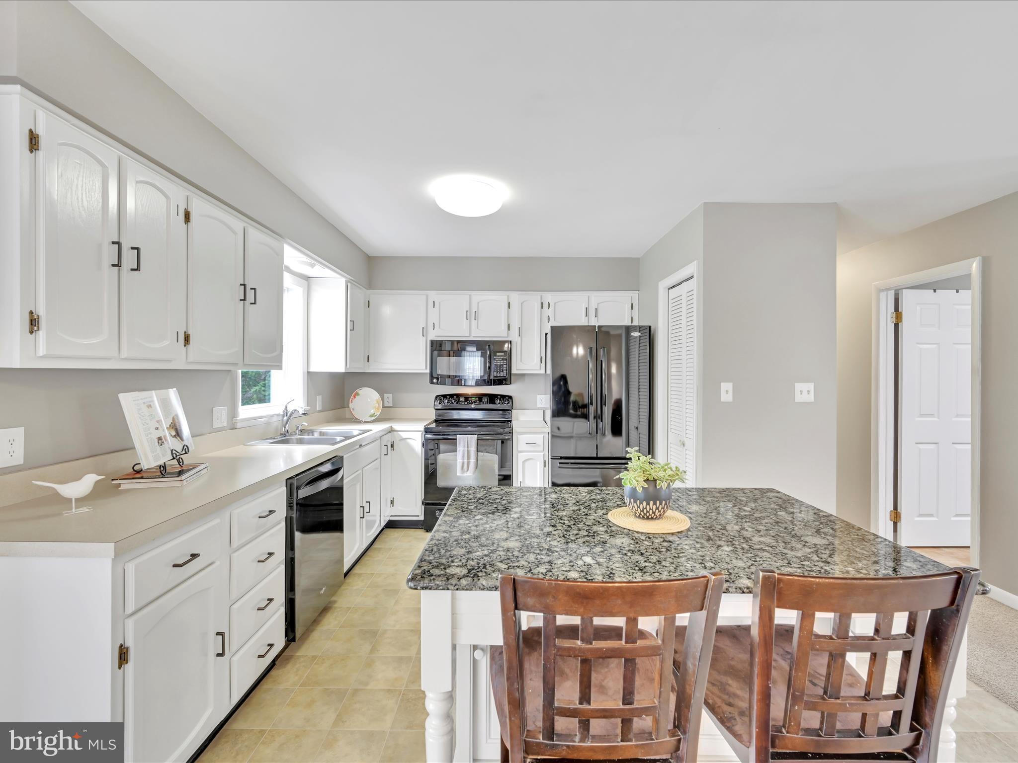 28 Buttonwood Drive Lititz, PA 17543 - Photo 9 of 32 a kitchen with a stove a sink and a refrigerator