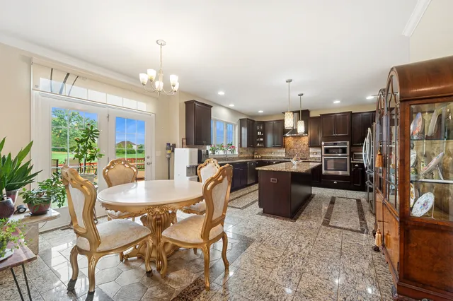 a living room with furniture a large window and a flat screen tv