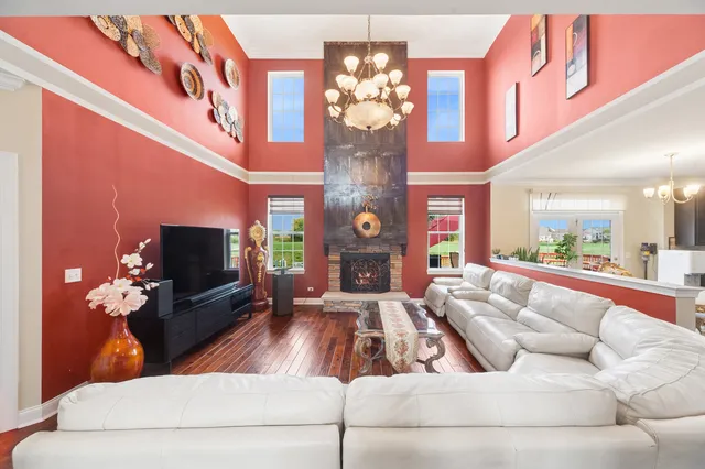 a living room with furniture a dining table and a fireplace
