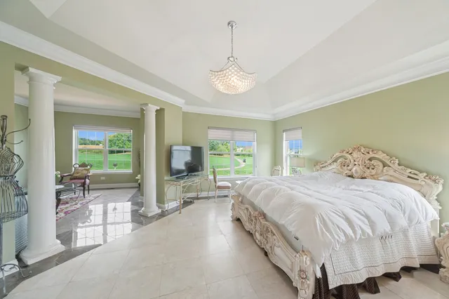 a bathroom with a granite countertop bathtub sink vanity mirror and toilet