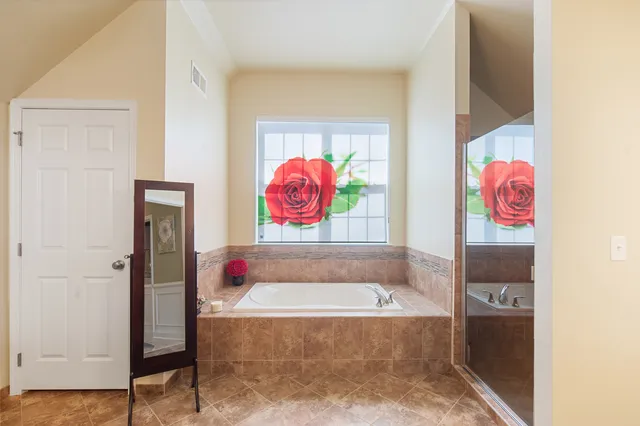 a living room with furniture a flat screen tv and next to a window