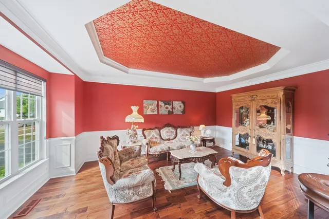 a kitchen with a dining table chairs stainless steel appliances and cabinets