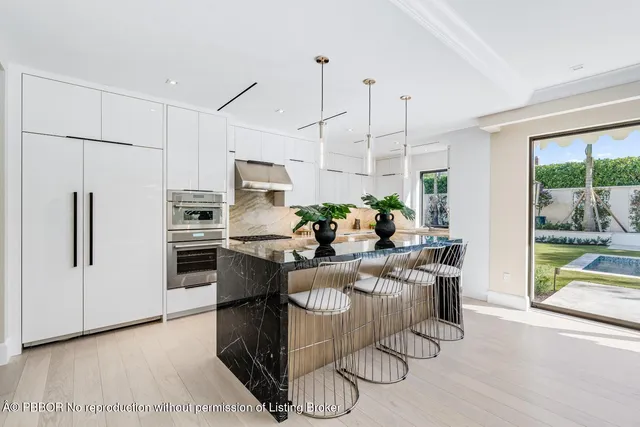a living room with large windows and a table