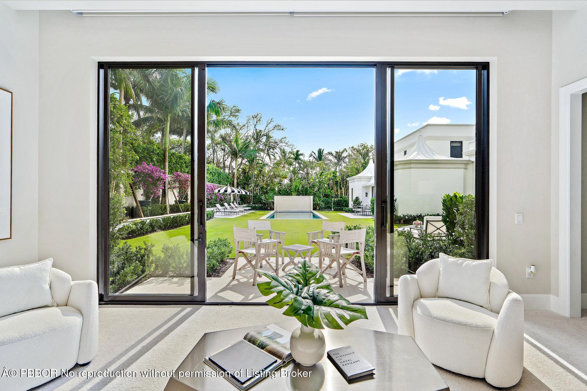 150 El Vedado Road Palm Beach, FL 33480 - Photo 23 of 77 a living room with large windows and a table