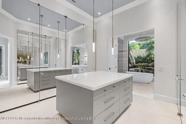 a bathroom with a toilet a sink a tub and a mirror