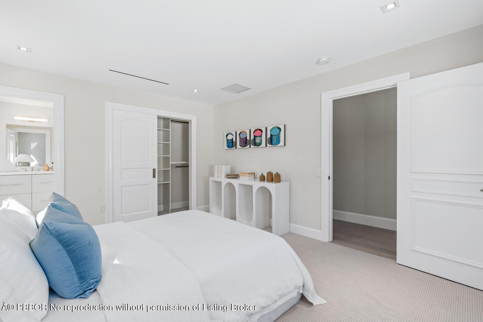 150 El Vedado Road Palm Beach, FL 33480 - Photo 37 of 77 a bedroom with a white bed and a chandelier