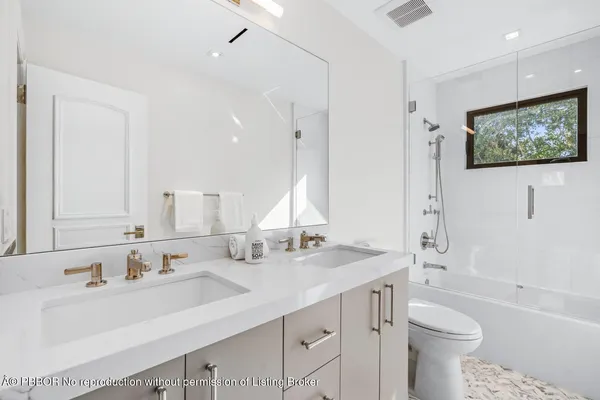 a view of a house with a yard and palm trees