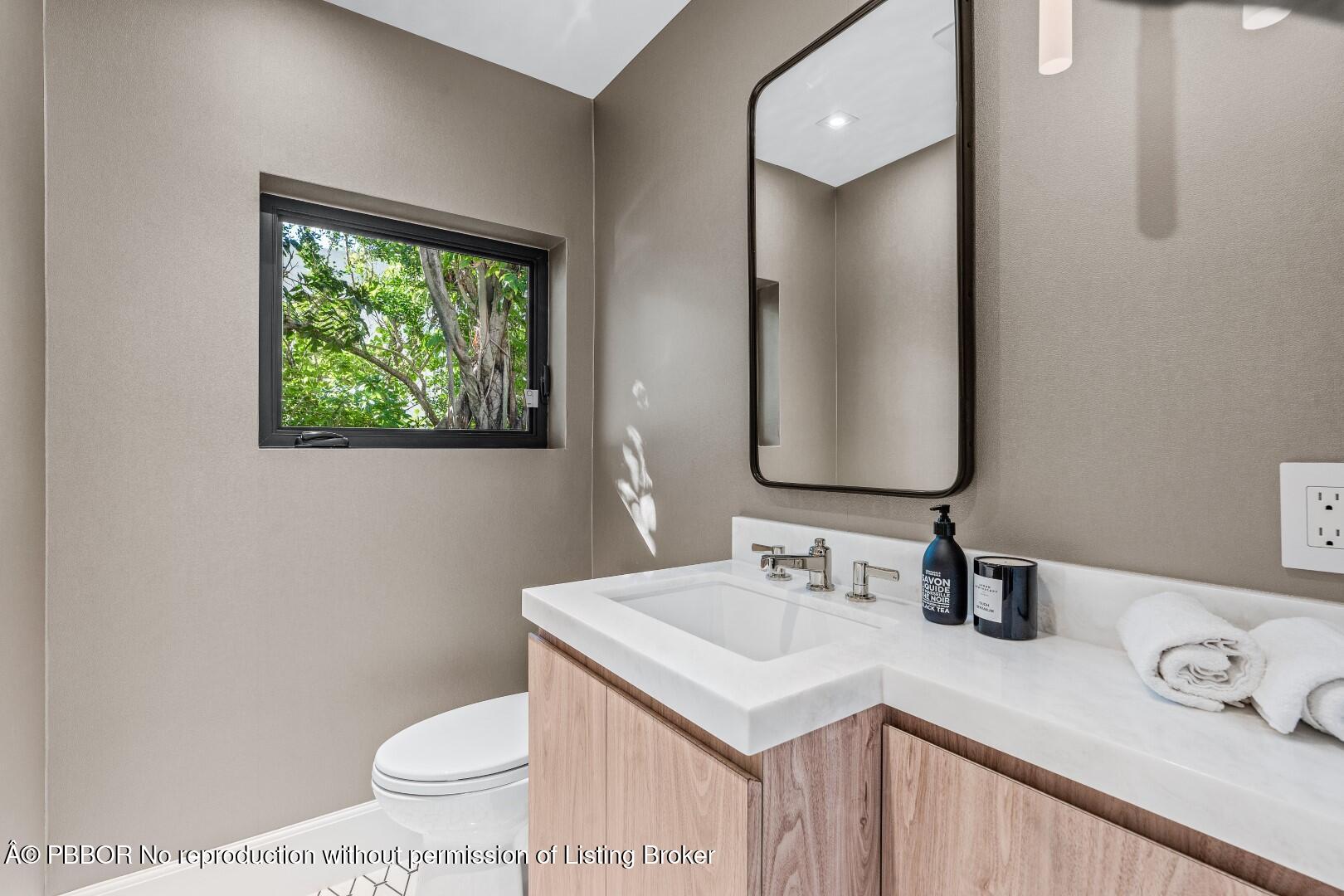 150 El Vedado Road Palm Beach, FL 33480 - Photo 45 of 77 a bathroom with a sink a toilet and mirror