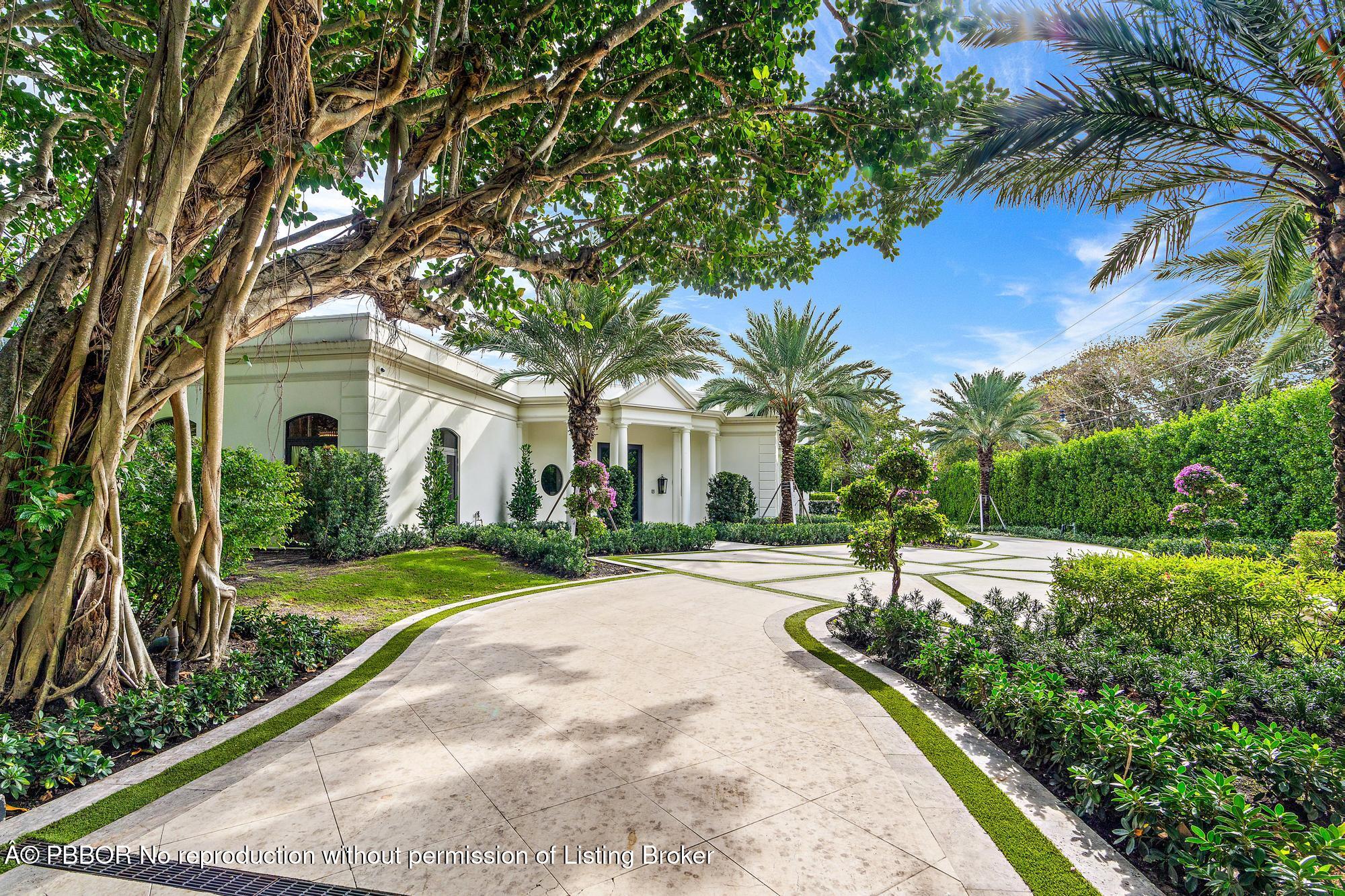 150 El Vedado Road Palm Beach, FL 33480 - Photo 58 of 77 a front view of a house with a yard and potted plants