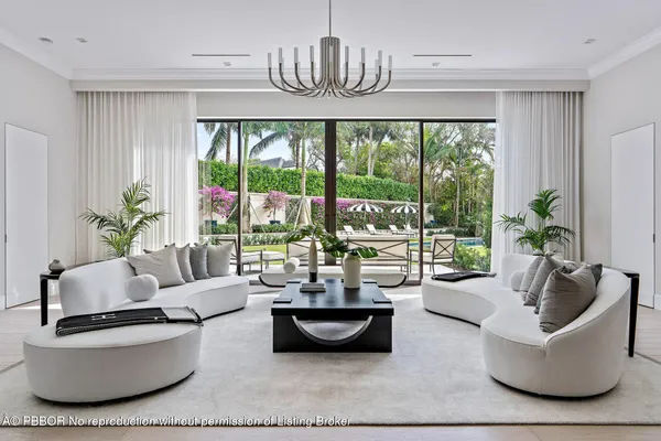 a dining room with furniture a chandelier and wooden floor