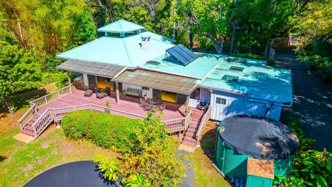 an aerial view of a house with swimming pool garden and patio