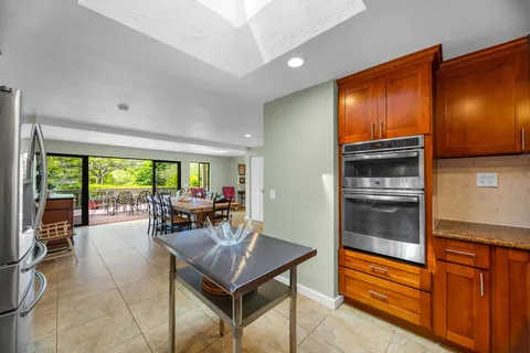a living room with glass door and furniture