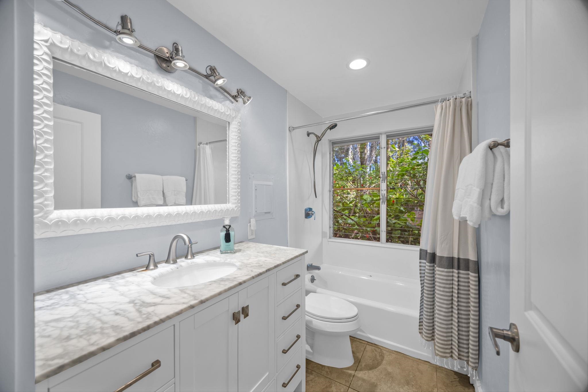 620 Awalau Road Haiku, HI 96708 - Photo 16 of 50 a bathroom with a granite countertop sink toilet and shower