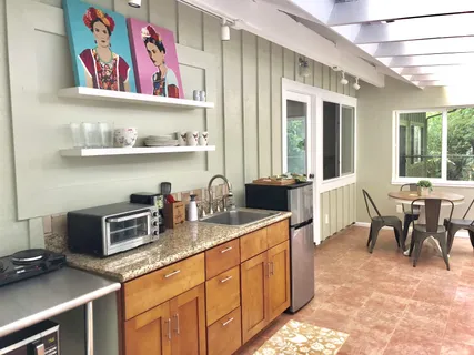 a kitchen with granite countertop lots of clutter and stainless steel appliances