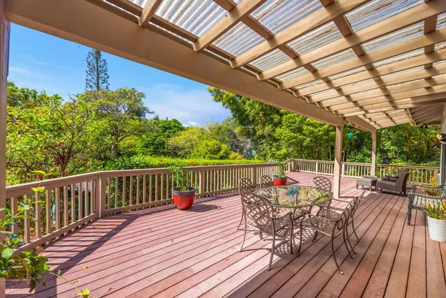 a view of balcony with wooden floor and outdoor seating