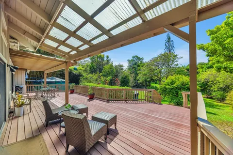 a view of balcony with chairs and wooden fence