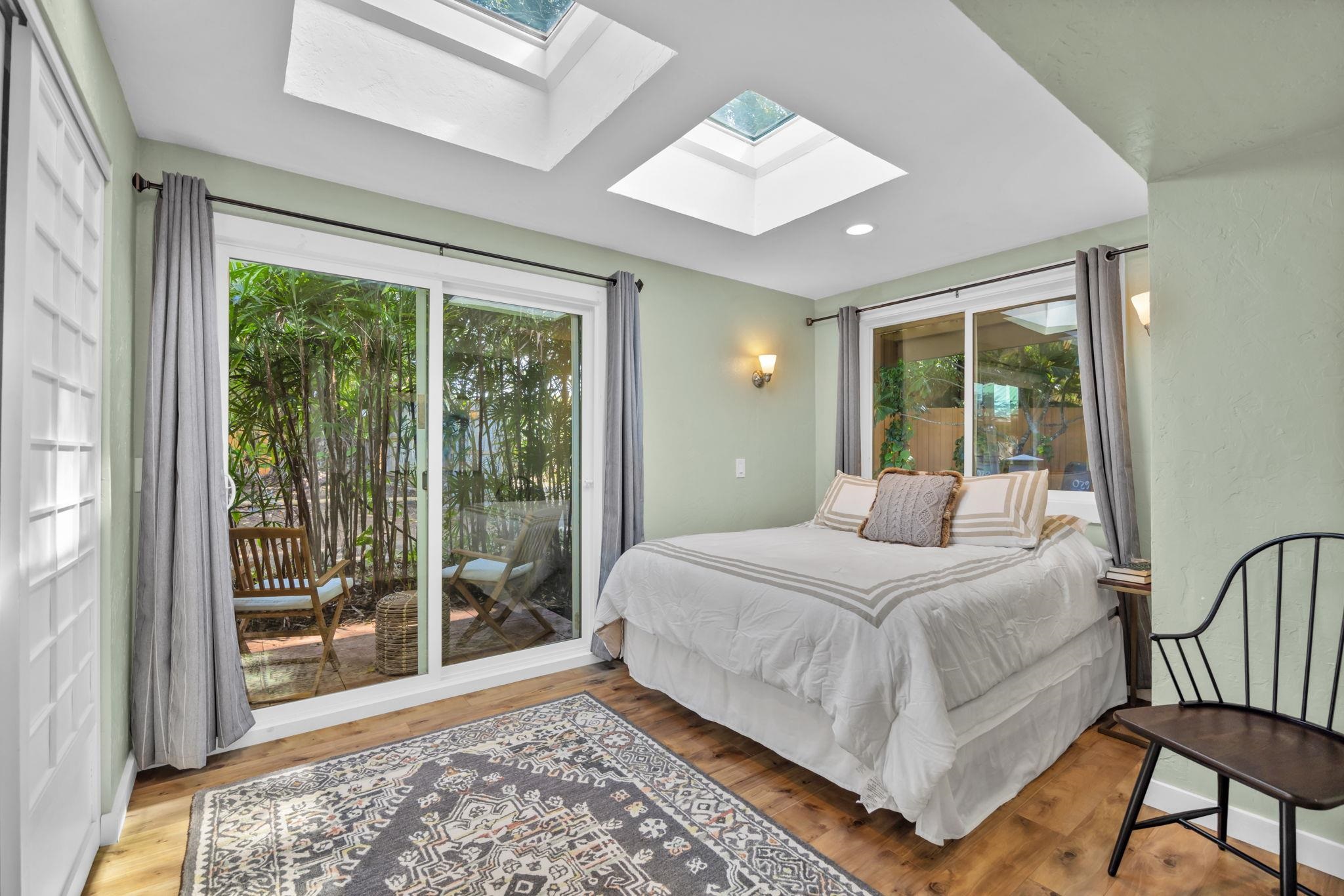 620 Awalau Road Haiku, HI 96708 - Photo 26 of 50 a bedroom with a large bed and a large window