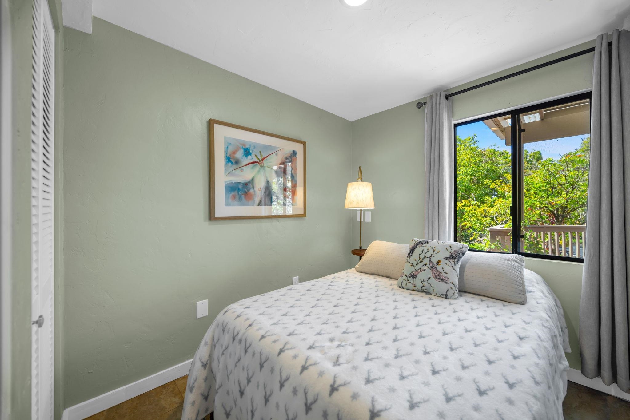 620 Awalau Road Haiku, HI 96708 - Photo 29 of 50 a bedroom with a bed and a window